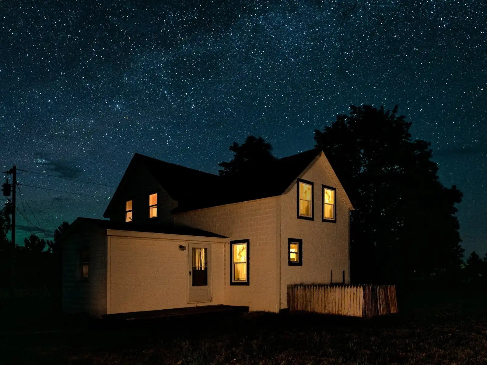 A house exterior at night with security lighting